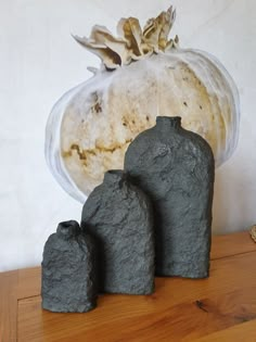 three small rocks sitting on top of a wooden table