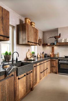 a kitchen with wooden cabinets and black counter tops is pictured in this image from the front view