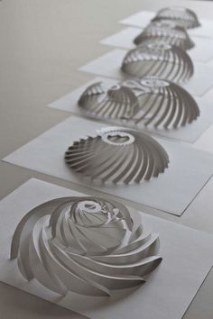 three paper cut designs on top of each other