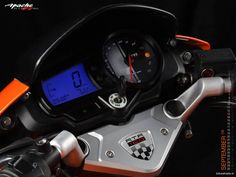 an orange and black motorcycle with the speedometer on