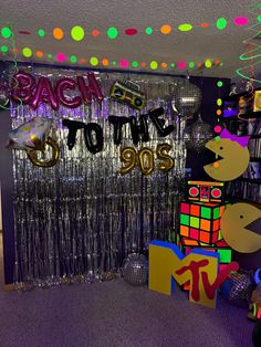 a room filled with disco balls and streamers that say back to the 90's