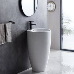 a white sink sitting next to a gray wall