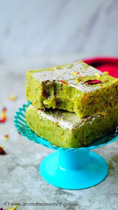 two pieces of green cake sitting on top of a blue plate