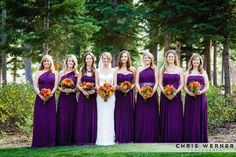 a group of women standing next to each other wearing purple dresses and holding bouquets