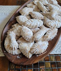 a wooden platter filled with pastries on top of a table