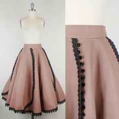 "Rare 1950s felt skirt by designer Melrod Ritter *Melrod Ritter designed as a hobby; her designs appeared in the windows of Berdorf's and Saks Fifth Avenue. One of her skirts appeared on the cover of Vogue 1951 on model Jeanne Patchett. She spent time with celebrities including Liz Taylor. Please DM us for photos! We obtained all information directly from Melrod Ritter's grandaughter! ~Taupe brown felted wool ~Black braided corde trim with velvet pom poms ~Side hook and eye closures ~Unlined Clean and ready to wear. Condition:  Very good. Faint spot on front/faint spots on side. Some bare spots/a few small holes and some holes that have been mended. Please DM for additional photos Size: Fits like a modern Medium *please consult measurements to ensure fit. Measurements Waist: 28\"(hooks cou Vintage Circle Skirt, Felt Skirt, Cover Of Vogue, 1950s Skirt, Designer Skirt, Tea Length Skirt, Liz Taylor, Elf Costume, Skirt Vintage