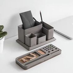 a desk with a pen, pencil holder and other office supplies