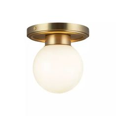 a light fixture with a white glass ball on the top and gold trimmings