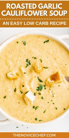 a bowl of roasted garlic cauliflower soup with a spoon in it and text overlay that reads roasted garlic cauliflower soup an easy low carb recipe