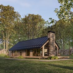 a small cabin style house in the middle of a field with trees and grass around it