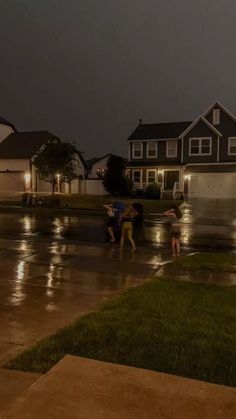 some people are standing in the rain with umbrellas