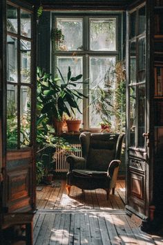 an open door leading to a living room with plants in the window and a chair