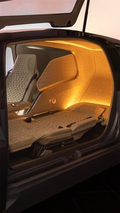 the interior of a car is lit up with yellow lights and there are no seats in it