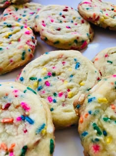 there are many cookies with sprinkles on the plate