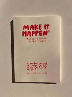 a white book with red writing on the front and back cover that says make it happen despite being super scared