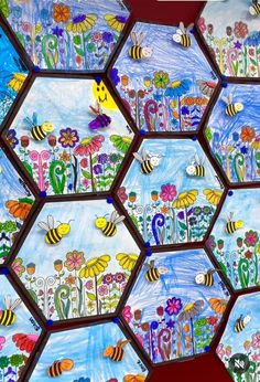 an art project with bees and flowers on the side of a wall made out of hexagons