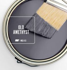 a paint can with a brush on top of it that says old amethyst