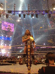 a man standing on top of a wrestling ring in front of confetti falling from the air