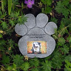 a memorial stone with a dog's paw on it