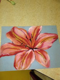 a painting of a pink flower on a blue background