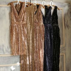 three dresses hanging on a rack in front of a wooden wall with the words atebo written