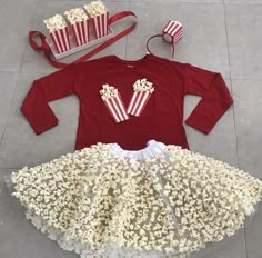 a child's costume made out of popcorn kernels and other items on the floor