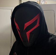 a person wearing a black and red mask