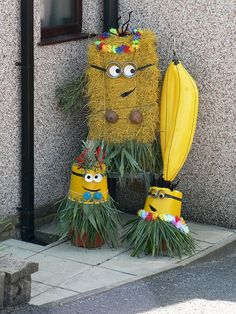 two fake plants with faces on them are next to a building