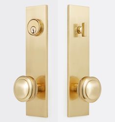 two golden door handles with knobs on each side and one has a keyhole in the middle