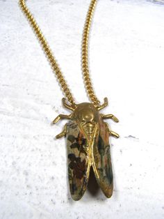 A unique handmade cicada pendant necklace. Floral hand decoupaged wings on brass base. Sealed but care should be taken as with all jewelry not to get it wet. Curb link chain and large lobster claw closure. 17 1/4" end to end including the closure. Cicada measures 2" top to bottom. Cicada Necklace, Eclectic Jewelry, Floral Cottagecore, Lovers Necklace, Insect Jewelry, Floral Necklace, Link Chain, Insects, Jewelry Necklace Pendant