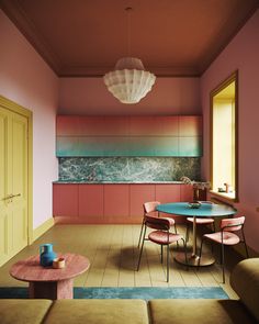 a living room filled with furniture and pink walls