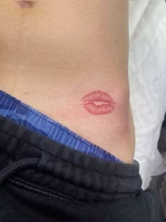 a woman's stomach with a red lip on the bottom of her stomach,