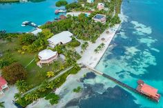 an aerial view of a tropical island with blue water