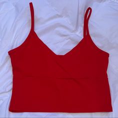 Perfect Condition, Never Worn. Super Cute Surplice Front That’s Very Flattering! Super Trendy Basic Top. Feel Free To Ask Any Questions! “Color: Red Style: Casual Pattern Type: Plain Type: Cami Neckline: Spaghetti Strap Length: Crop Fit Type: Slim Fit Fabric: Slight Stretch Material: Cotton Composition: 95% Cotton, 5% Spandex Care Instructions: Machine Wash Or Professional Dry Clean Chest Pad: No Padding Sheer: No Chic Red Tank Top With Built-in Bra, Red Seamless V-neck Top, Red Seamless Cami Top, Red Cami Crop Top For Party, Chic Red Cropped Tank Top, Fitted Red V-neck Tank Top, Trendy Red V-neck Tank Top, Red Cami Crop Top For Spring, Red Seamless Crop Top Tank