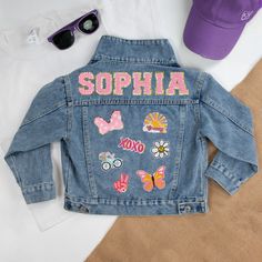 a denim jacket with embroidered butterflies on the back and name sophiia written in pink