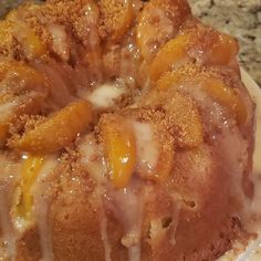 a close up of a cake on a plate with icing and oranges around it