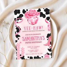 a pink and black minnie mouse birthday party card on a white plate with flowers in the background