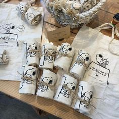 several bags with peanuts tied to them sitting on a table next to some other items