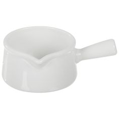 a white ceramic bowl with a handle on the side and an empty spoon in it