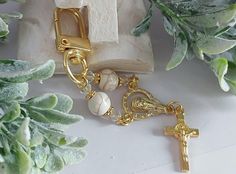 Handmade mini rosary key hanger comes in gold or silver, has a marble looking beads (Howlite) with Swarovski crystals. Beads size 8/4mm  Aprox 4 inch from the top to the bottom of the cross. Stunning gift for so many occasions, New born guest gift, Communion, Christening or a wedding. Custom orders are available, please message me for any questions. For more colours follow that link https://www.etsy.com/au/listing/1790832354/custom-mini-rosary-keychainbaptism?click_key=915ed6d0f52a1ba0acdce55d7f Elegant Gold Rosary For Gift, Rosary Keychain, Adjustable Gold Rosary For Baptism, Personalized Rosary With Round Beads For Baptism, Gold Hand-strung Spiritual Rosary, Mini Rosaries, Hand-strung Rosary With Round Beads As Gift, Communion Favors, Key Hanger