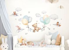 a child's room with teddy bears, stars and balloons on the wall above it