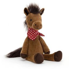 a brown stuffed horse with a red polka dot ribbon on it's neck sitting in front of a white background