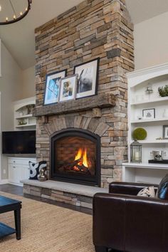 a living room filled with furniture and a fire place next to a tv mounted on a wall