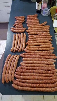 several large sausages laid out on a counter top