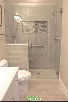 a bathroom with a walk in shower next to a toilet