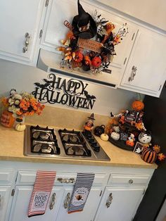 a kitchen decorated for halloween with pumpkins and decorations