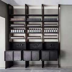 the shelves are full of bottles and containers for hair care products in an empty room