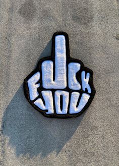 a blue and white sticker with the word rock written in it's middle