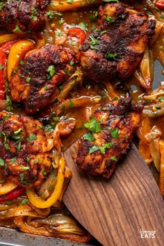 chicken with peppers and onions in a pan