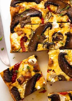 sliced pizza with mushrooms and cheese on a white plate